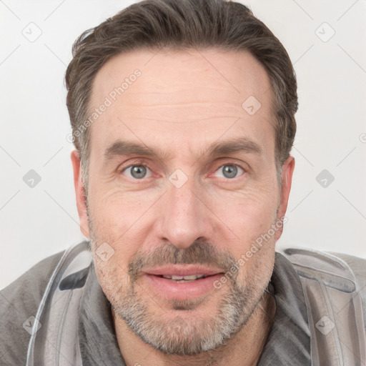 Joyful white adult male with short  brown hair and grey eyes