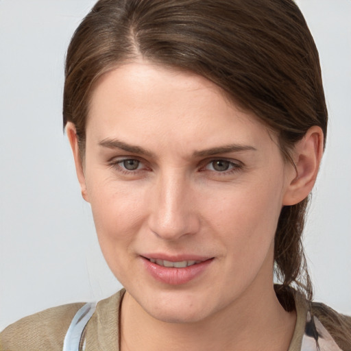 Joyful white young-adult female with medium  brown hair and grey eyes