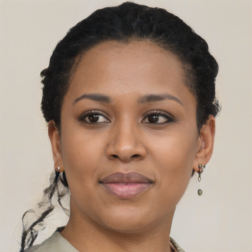 Joyful black young-adult female with short  brown hair and brown eyes