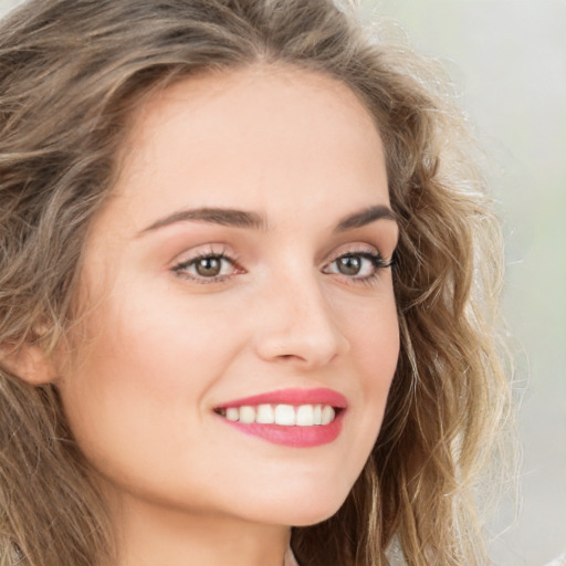 Joyful white young-adult female with long  brown hair and green eyes