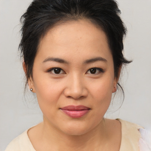 Joyful asian young-adult female with medium  brown hair and brown eyes
