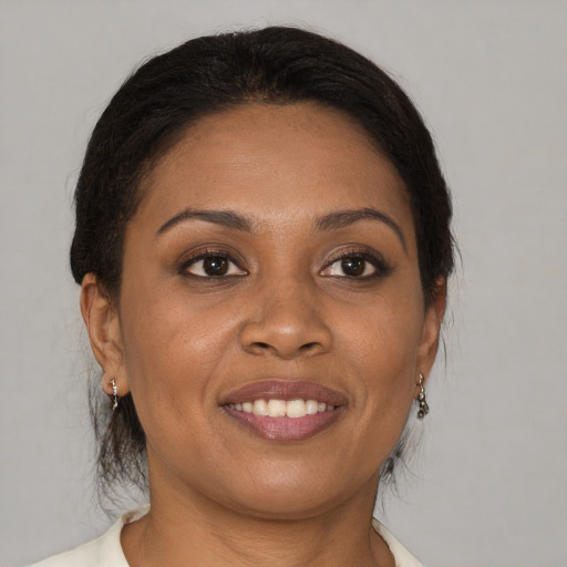 Joyful black young-adult female with medium  brown hair and brown eyes