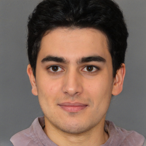 Joyful latino young-adult male with short  black hair and brown eyes