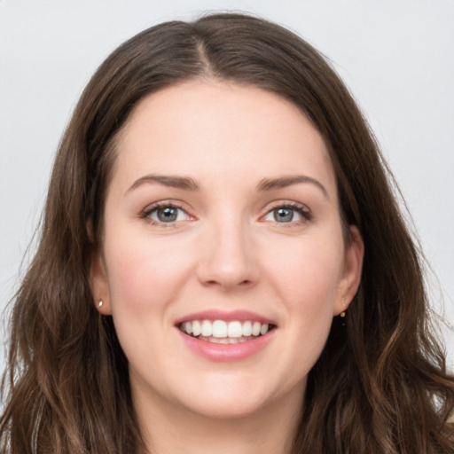 Joyful white young-adult female with long  brown hair and grey eyes