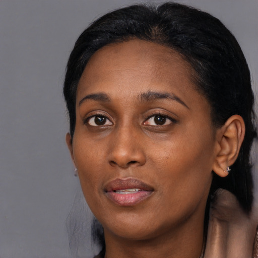 Joyful black young-adult female with medium  black hair and brown eyes