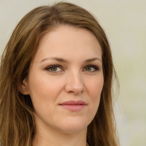 Joyful white young-adult female with long  brown hair and green eyes