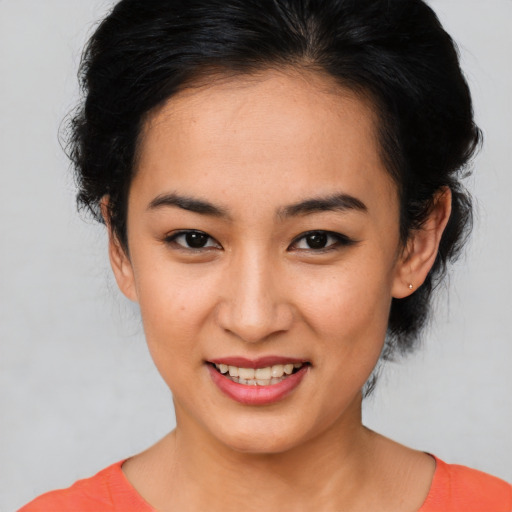 Joyful asian young-adult female with medium  brown hair and brown eyes