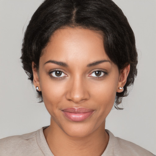 Joyful black young-adult female with medium  brown hair and brown eyes