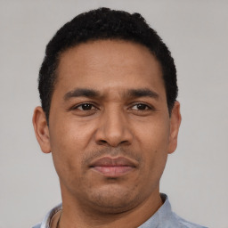 Neutral latino adult male with short  black hair and brown eyes