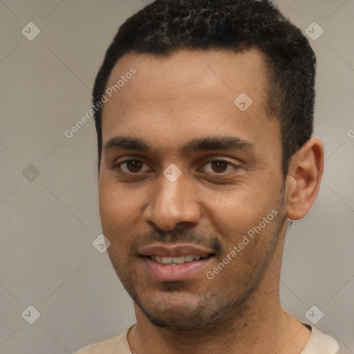 Joyful white young-adult male with short  black hair and brown eyes