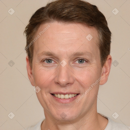 Joyful white adult male with short  brown hair and grey eyes