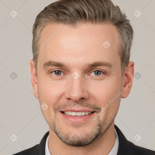 Joyful white adult male with short  brown hair and brown eyes