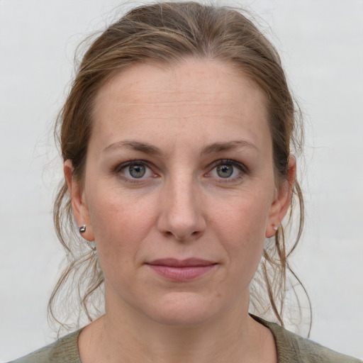 Joyful white adult female with medium  brown hair and grey eyes