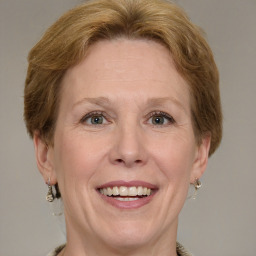 Joyful white adult female with medium  brown hair and green eyes