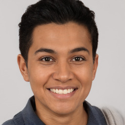 Joyful latino young-adult male with short  brown hair and brown eyes