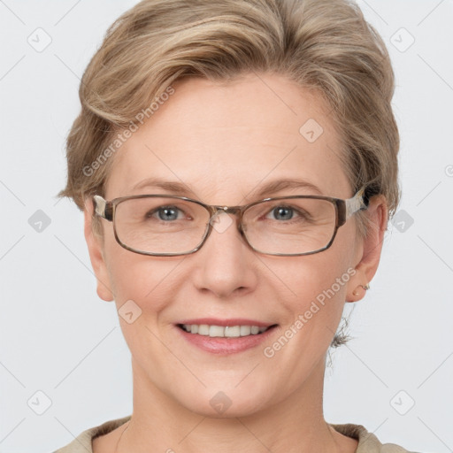 Joyful white adult female with short  brown hair and blue eyes