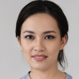 Joyful asian young-adult female with medium  black hair and brown eyes