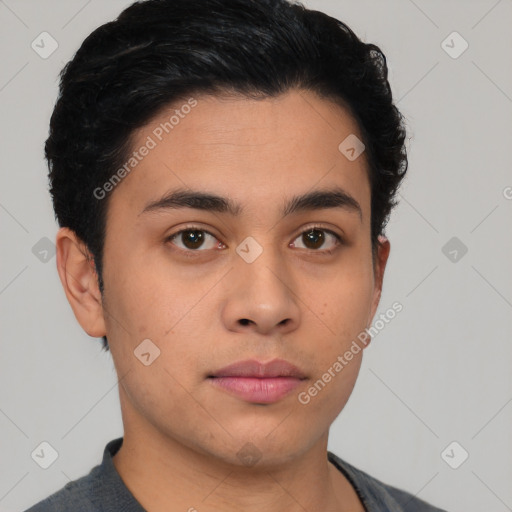 Neutral latino young-adult male with short  black hair and brown eyes