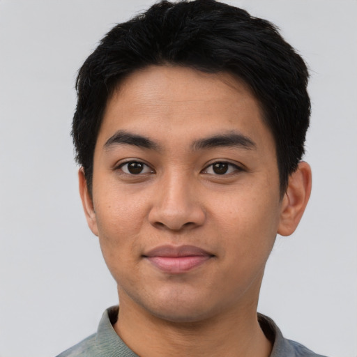 Joyful asian young-adult male with short  black hair and brown eyes