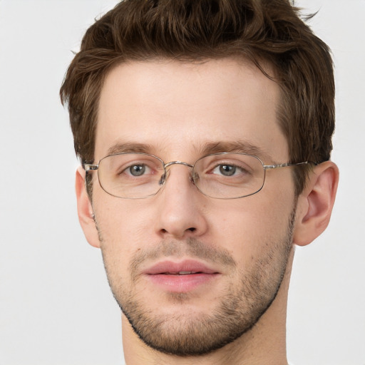 Joyful white adult male with short  brown hair and grey eyes