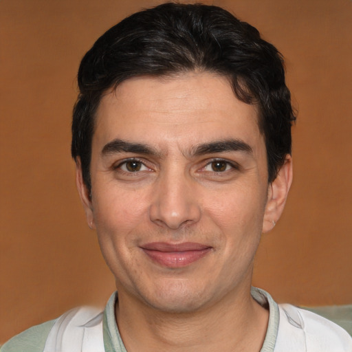 Joyful white adult male with short  brown hair and brown eyes