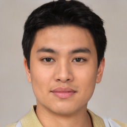 Joyful asian young-adult male with short  black hair and brown eyes