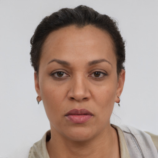 Neutral latino adult female with short  brown hair and brown eyes