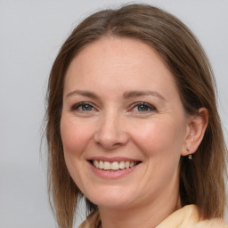 Joyful white adult female with medium  brown hair and grey eyes