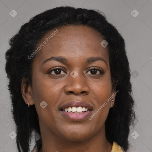 Joyful black young-adult female with long  black hair and brown eyes