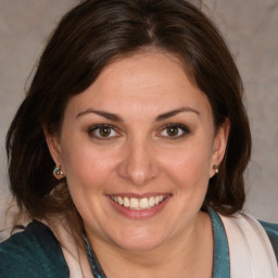 Joyful white adult female with medium  brown hair and brown eyes