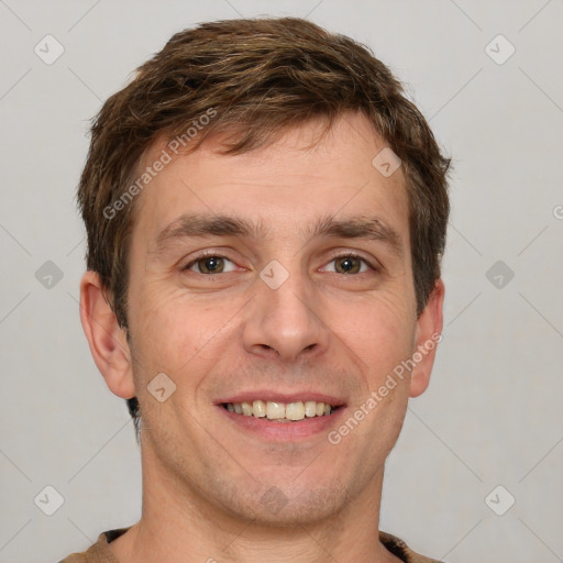 Joyful white adult male with short  brown hair and grey eyes