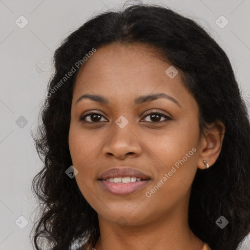 Joyful black young-adult female with long  brown hair and brown eyes