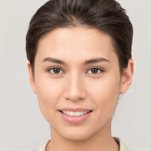 Joyful white young-adult female with medium  brown hair and brown eyes