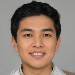 Joyful asian young-adult male with short  black hair and brown eyes