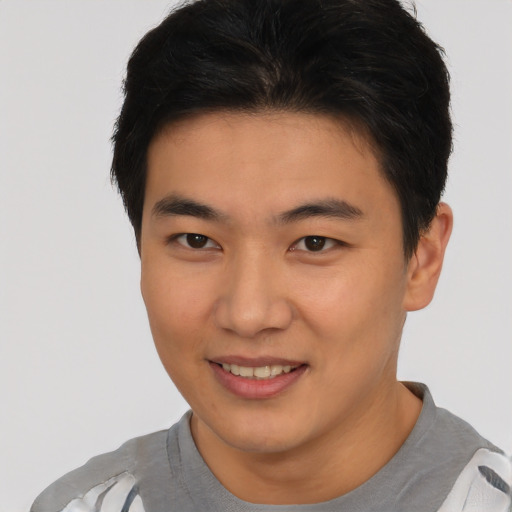 Joyful asian young-adult male with short  brown hair and brown eyes