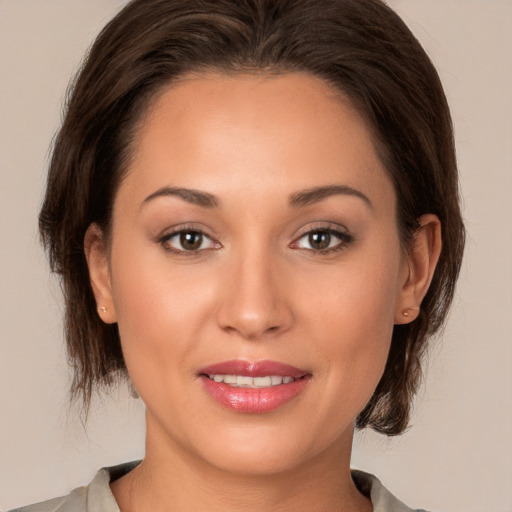 Joyful white young-adult female with medium  brown hair and brown eyes