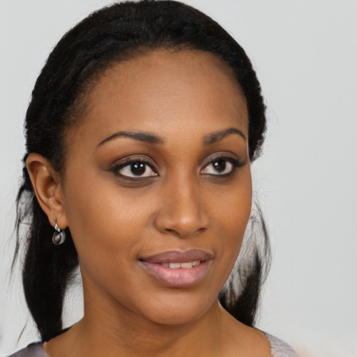Joyful black young-adult female with medium  black hair and brown eyes