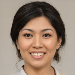 Joyful asian young-adult female with medium  brown hair and brown eyes