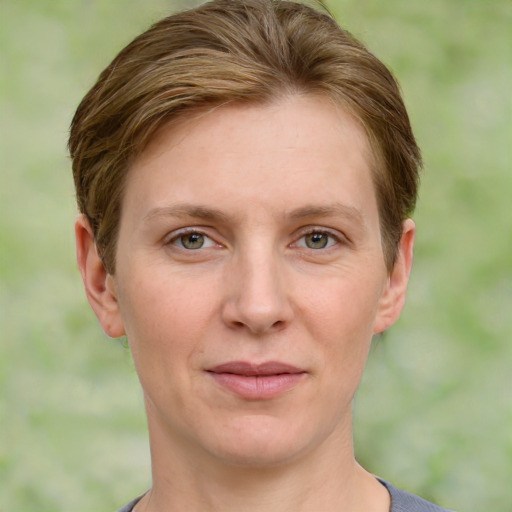 Joyful white adult female with short  brown hair and grey eyes