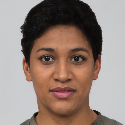 Joyful latino young-adult female with short  black hair and brown eyes