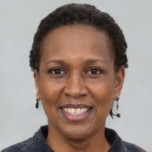 Joyful black adult female with short  black hair and brown eyes