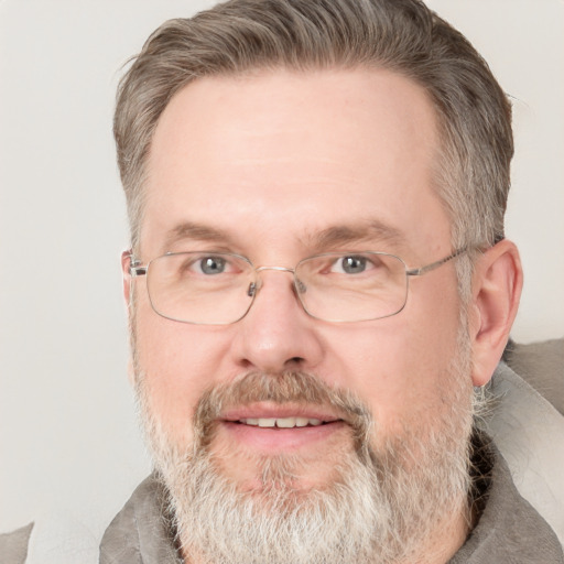 Joyful white middle-aged male with short  brown hair and grey eyes