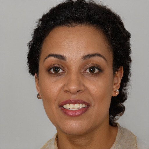 Joyful black adult female with short  brown hair and brown eyes