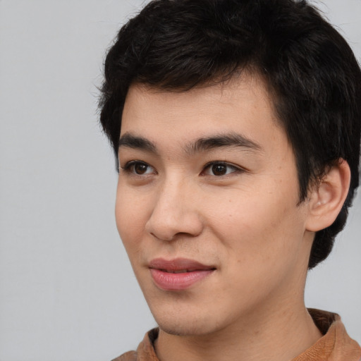 Joyful asian young-adult male with short  black hair and brown eyes