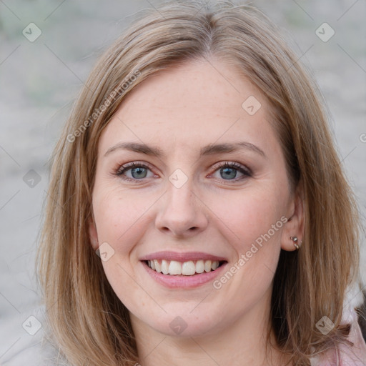 Joyful white young-adult female with medium  brown hair and blue eyes