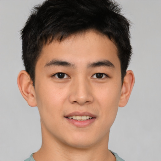 Joyful asian young-adult male with short  brown hair and brown eyes