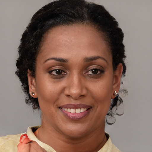 Joyful latino adult female with short  brown hair and brown eyes