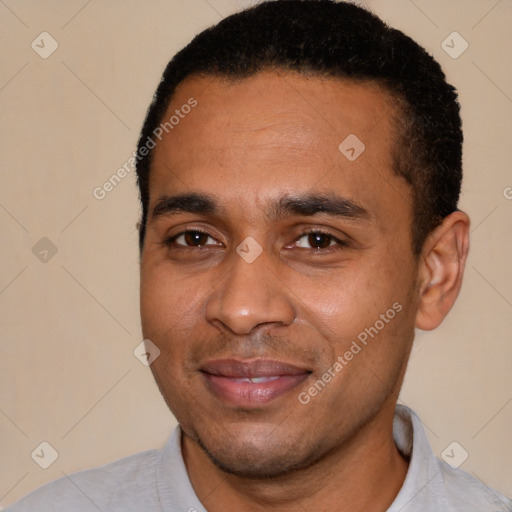 Joyful latino young-adult male with short  black hair and brown eyes