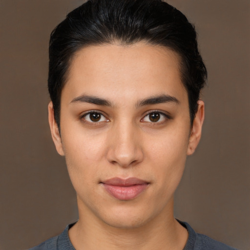 Joyful latino young-adult female with short  brown hair and brown eyes