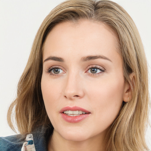 Joyful white young-adult female with long  brown hair and blue eyes